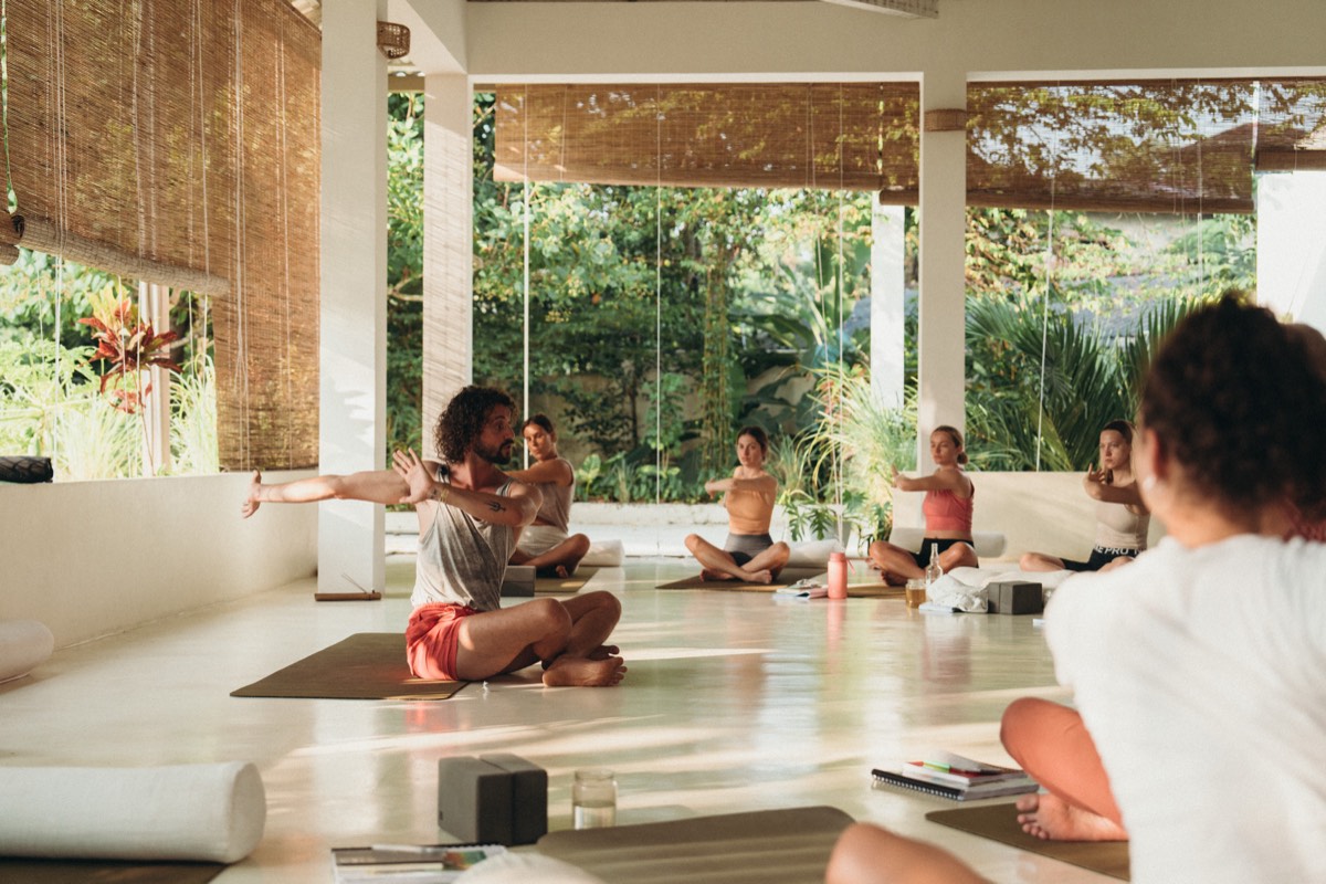 Trainees at Lanka Yoga in Sri Lanka moving their own arms and shoulders through range, with no hands, straps or props assisting