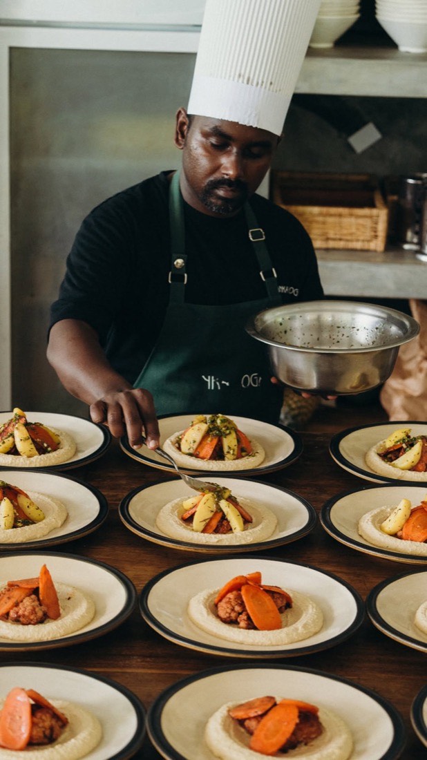A chef plating fresh vegan dishes in the Lanka Yoga kitchen, Sri Lanka