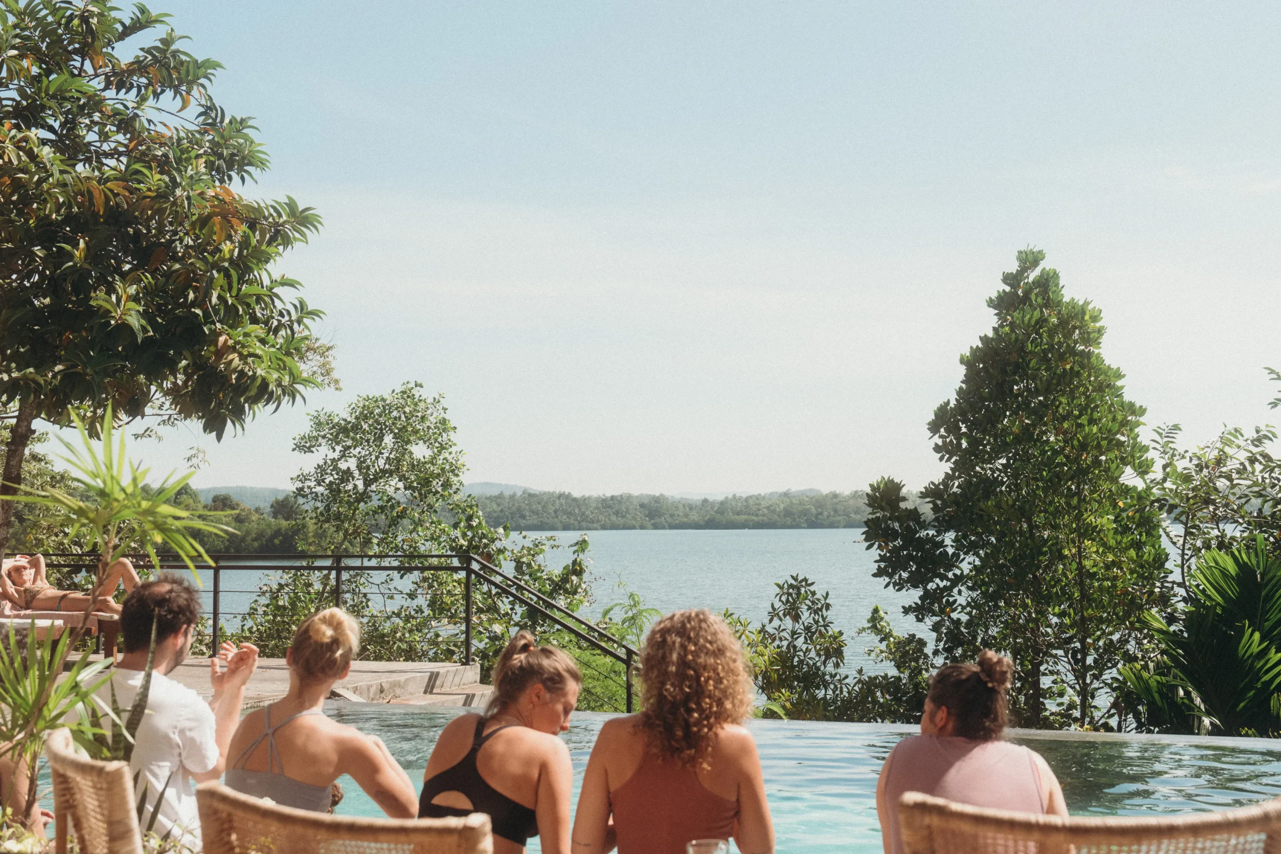 Lanka-Yoga-retreat-pool-time a group of people sitting in chairs by a pool
