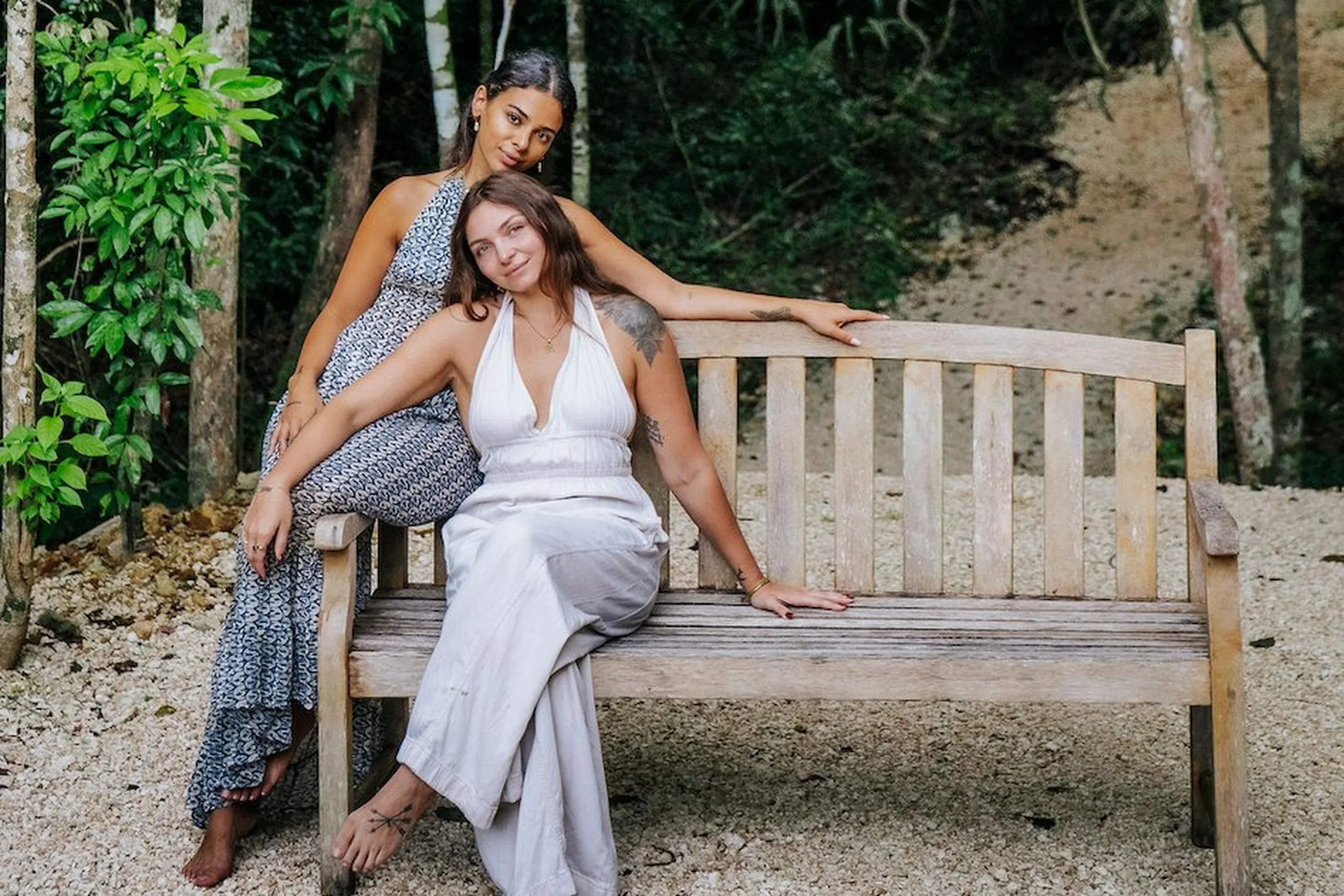 Two women relaxing on a wooden bench surrounded by jungle at Lanka Yoga, Sri Lanka — Inner Compass retreat with Farah Bernard